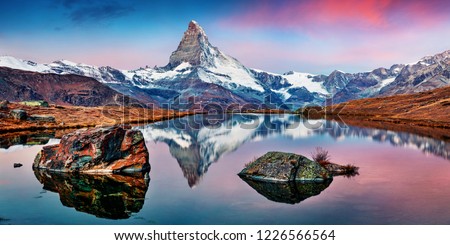 Panoramic morning view of Stellisee lake with Matterhorn / Cervino peak on background. Impressive autumn scene of Swiss Alps, Zermatt resort location, Switzerland, Europe.  Royalty-Free Stock Photo #1226566564