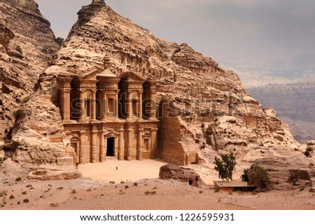 El Deir - The Monastery at Petra, Jordan with a person standing in front.