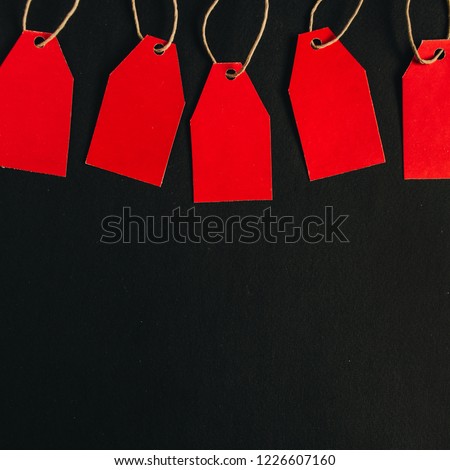 Black Friday sales discount composition. Red tags on black background. Hero Header. Flat lay, top view.