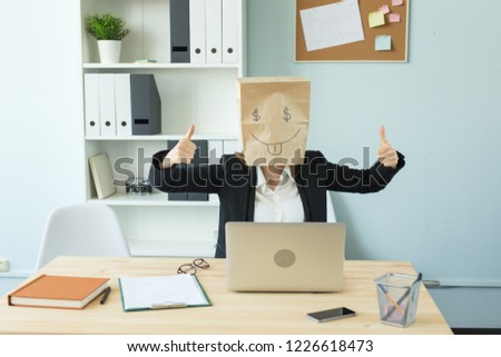 Business, emotions and money concept - office crazy woman put a package with painted funny face on her head. Dollar sign in her eyes