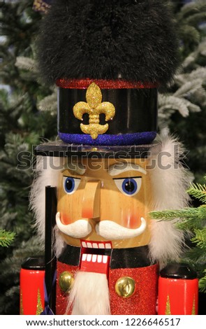 Cute English nutcracker doll or Christmas nutcracker resembling a British soldier of the Queen life guard. Wooden handcrafted painted in bright colors. Winter decoration or toy. Tradition from Germany