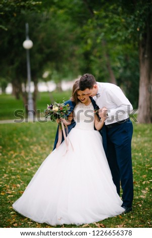 Bride and groom in the park in autumn
