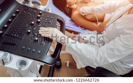 Gynecologist performing breast examination for her patient using ultrasound scanner. Sonography. Medical equipment healthcare. Ultrasound scanning. Diagnostic, healthcare, medical service Royalty-Free Stock Photo #1226662726