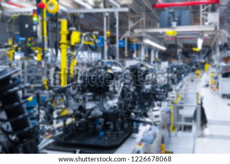 Blurred background internal parts of car. Defocused image of car suspension. Car factory background