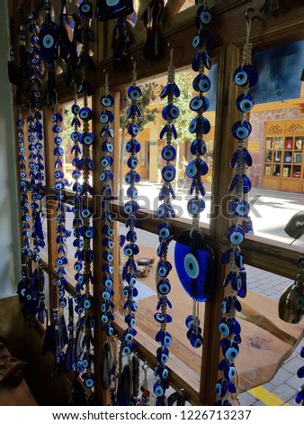 The branches of the old tree decorated with the eye-shaped amulets - Nazars, made of blue glass and believed to protect against the evil eye.