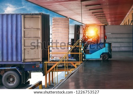 Forklift handling empty tin cans from container into warehouse. Distribution, Logistics Import Export, Warehouse operation, Trading, Shipment, Delivery concept. Royalty-Free Stock Photo #1226753527