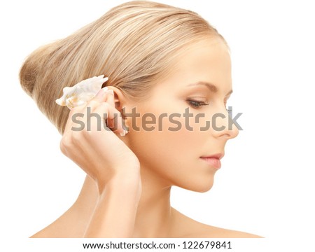 bright closeup portrait picture of beautiful woman with seashell..