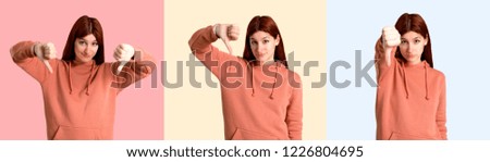 Set of Young redhead girl with pink sweatshirt showing thumb down sign with negative expression. Sad expression on colorful background