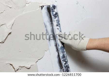 Construction worker plastering and smoothing concrete wall with cement 
 Royalty-Free Stock Photo #1226811700
