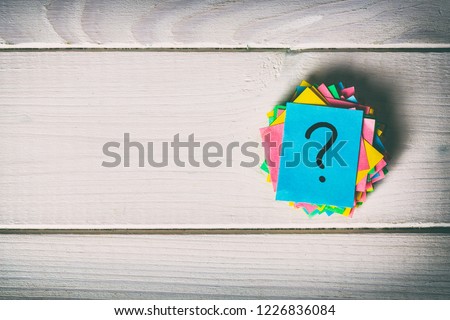 Just a lot of question marks on colored papers. vintage background.