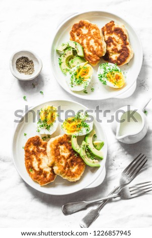 Served brunch table - potato scones and boiled eggs on a light background, top view. Delicious breakfast, snack, appetizer