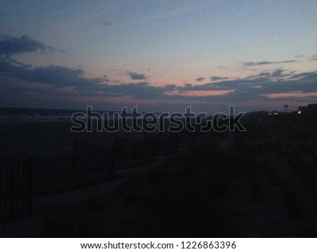 Colorful sky during red and purple sunset over the ocean on the outer banks in Hatteras island, North Carolina, USA