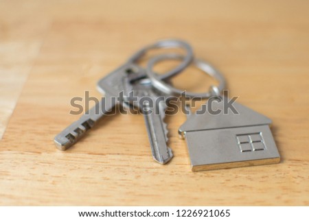 home key on wooden table. soft focus.