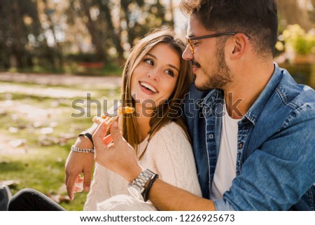 Couple at the park eating pizza