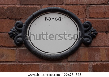 Decorative address sign on side of brick building