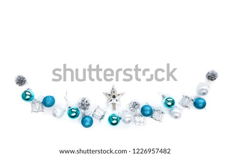 Christmas tree decorative ornaments of silver star, blue balls, pine cone, tinsels and drums over white background with copy space for winter Merry X'mas text insertion, logo or product decoration