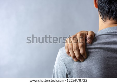 Middle aged man has shoulder pain. with copy space for text Royalty-Free Stock Photo #1226978722