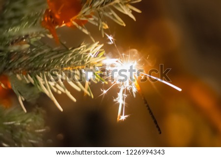 glowing sparkler against blurred background