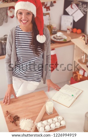 Woman making christmas cookies in the kitchen
