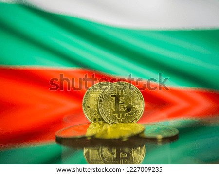 Bitcoin gold coin and defocused flag of  Bulgaria background. Virtual cryptocurrency concept.