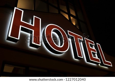View of glowing hotel sign at night