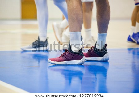 Legs in sneakers. Basketball team at the gym