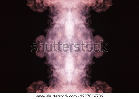 Abstract thick colored smoke on a black background with a monster face. The concept of a light laser show at a musical concert and a print on a T-shirt