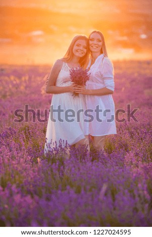 Happy mom with cute son and sister on lavender background. Lavender landscape with lady and kid enjoying aroma and vivid colors. Family picture in colorful lavender view.