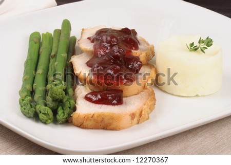 organic turkey breast  with cranberry sauce and fresh asparagus