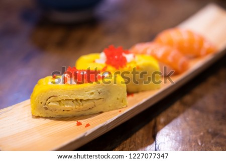 Traditional Japanese cuisine.Various kinds Sushi Set sashimi and sushi rolls. Fresh made Sushi set with salmon, prawns, wasabi and ginger in restaurant.Selective focus