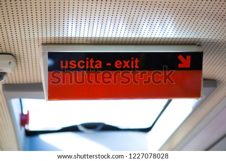 Black and red sign in the Italian bus: Uscita - Exit; Fermata Prenotata - Stop Requested