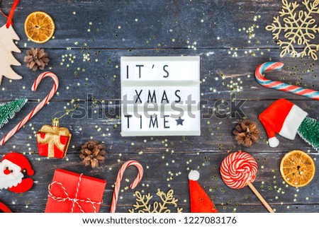 New Year or Christmas decoration flat lay top view Xmas holiday celebration handmade gift boxes on dark wooden background. Template mockup for greeting card or your text design