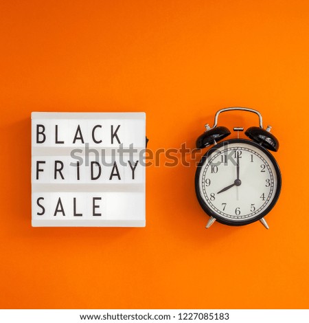 Creative Top view flat lay promotion composition Black friday sale text on lightbox alarm clock orange background copy space Square Template Black friday sale mockup fall thanksgiving advertising
