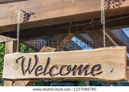 Homemade inviting wooden sign with the inscription Welcome