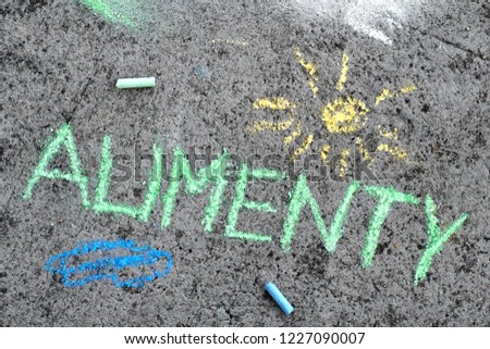 Colorful chalk drawing on asphalt: Polish word ALIMONY and yellow sun