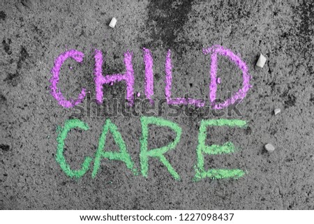 Colorful chalk drawing on asphalt: words CHILD CARE