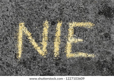 Colorful chalk drawing on asphalt: Polish word NO