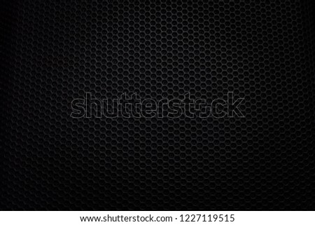 Abstract black metallic mesh texture pattern for background. Industrial backdrop. The speaker of a musical column. Free space for text.