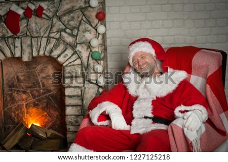 Santa Claus for Christmas in a room with a fireplace