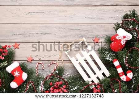 Christmas fir tree branches with decorations on wooden table
