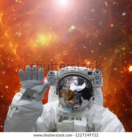 Astronaut waves. The elements of this image furnished by NASA.
