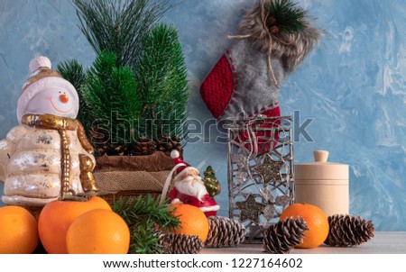Christmas composition of Christmas objects with a Christmas tree and a snowman. New Year's decoration. Tangerines with persimmon. Christmas.