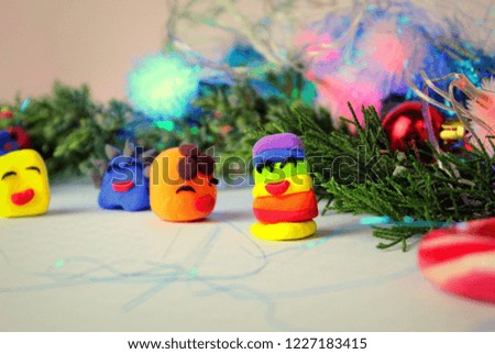 Christmas themes, air plasticine figurines on a light table, selective focus.