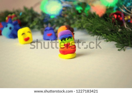 Christmas themes, air plasticine figurines on a light table, selective focus.