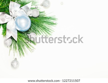 pine twigs green spruce and new year toys blue silver in the corner greeting card on a white background isolate place for text corner photo