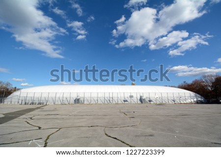 Basketball Courts In McCarren Park with Tennis Courts Under Air Supported Dome Behind Royalty-Free Stock Photo #1227223399