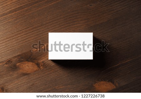 Blank business card on wood table background. Template for branding identity. Flat lay.