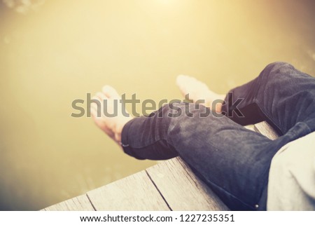 Man sitting on the wood bridge