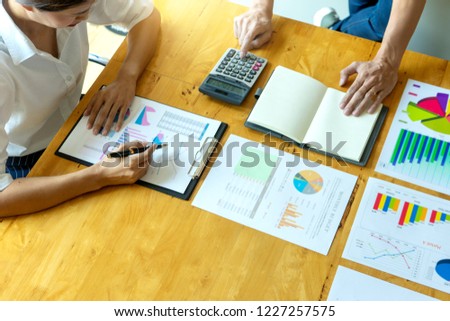 business businessman and woman in meeting analyses chart graphy marketing plan in business project
