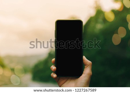 Woman hand using smartphone copy space black background. Business, financial, trade stock maket and social network concept.